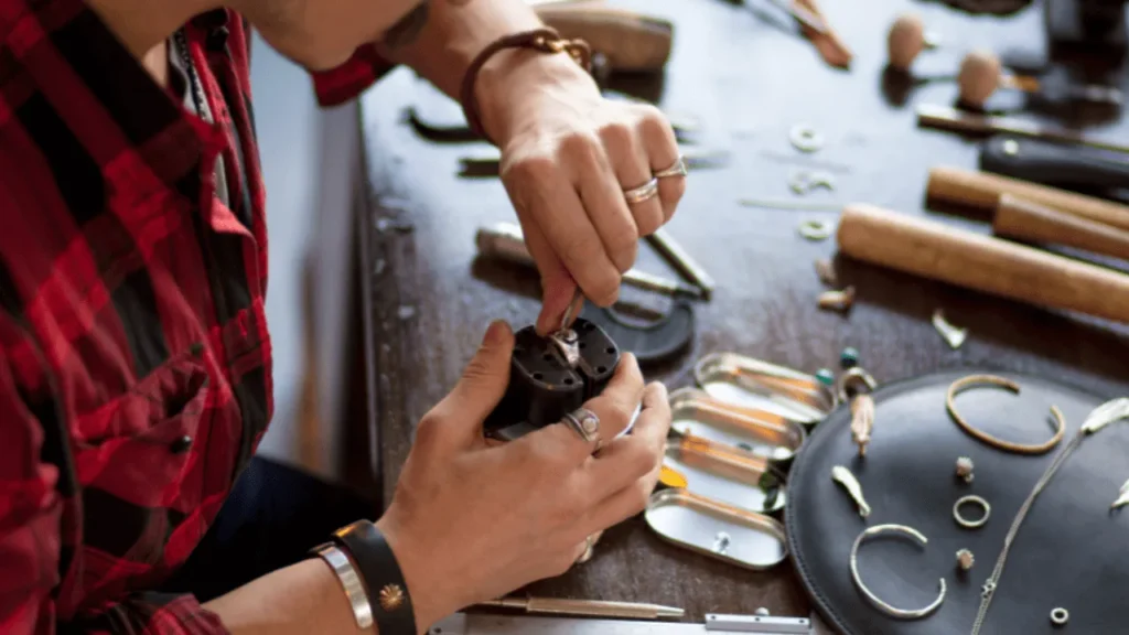 Artisan engraving custom jewelry in the Philippines using precision tools